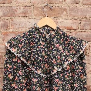 Sezane Victorian style top in navy floral pattern with white trim.